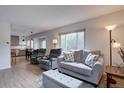 Bright living room features neutral decor, recessed lights, and wood flooring at 1769 S Lee St # B, Lakewood, CO 80232