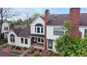 Well-maintained townhome featuring a brick chimney, landscaped yard, and a cozy covered entrance at 7682 S Steele St, Centennial, CO 80122
