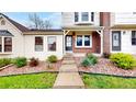 Charming townhome entrance with landscaped front yard and a cozy covered porch at 7682 S Steele St, Centennial, CO 80122
