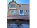 Back exterior of home showing deck, sliding glass door, and neutral colored siding at 1148 S Duquesne Cir, Aurora, CO 80018