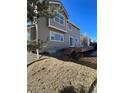 Neutral colored house exterior showing deck with a large backyard and blue sky at 1148 S Duquesne Cir, Aurora, CO 80018