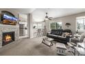 Comfortable living room with modern fireplace, TV, and view into bright, updated kitchen at 6840 Xavier Cir # 5, Westminster, CO 80030