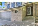 Inviting two-story home showcasing a brick facade, a three-car garage, and a decorative window detail at 2552 E 126Th Way, Thornton, CO 80241