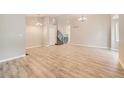Spacious living room with light wood floors and modern chandelier at 2552 E 126Th Way, Thornton, CO 80241