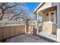 A private courtyard with a quaint fence and brick pillar entrance to the home at 9938 Grove Way # B, Westminster, CO 80031