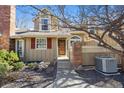 Close up of a home with a brick entryway, red shuttered window and manicured garden at 9938 Grove Way # B, Westminster, CO 80031