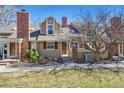 Inviting exterior featuring a prominent brick chimney, complemented by well-maintained landscaping at 9938 Grove Way # B, Westminster, CO 80031