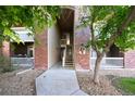 Attractive condo building with brick entryway and lush greenery, offering a welcoming and well-maintained exterior at 8481 W Union Ave # 2-201, Littleton, CO 80123