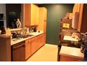 Functional kitchen with wooden cabinetry, stainless steel appliances, and efficient layout at 14353 E 1St Dr # 201, Aurora, CO 80011