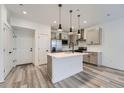 Modern kitchen with a waterfall island, gray cabinets and stainless steel appliances at 27742 E 1St Ave, Aurora, CO 80018