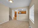 Bright living room with tile floors, open view to kitchen, and stairs at 6671 Grove St, Denver, CO 80221