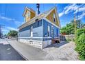 Blue two-story home featuring a vintage chimney and rear entryway at 523 W 8Th Ave, Denver, CO 80204