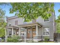 Inviting gray brick duplex featuring covered front porches, offering a blend of classic charm at 2562 N Emerson St, Denver, CO 80205