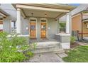 Charming porch with twin front doors and classic pillars, inviting entry to a well-maintained home at 2562 N Emerson St, Denver, CO 80205