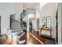 Elegant entryway with a curved staircase and hardwood floors at 415 S Snowmass Cir, Superior, CO 80027