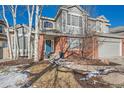 Two-story home with gray siding and a brick facade at 415 S Snowmass Cir, Superior, CO 80027