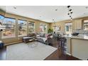Bright living space with a comfortable sectional couch and large windows showcasing outdoor views at 15851 Josephine Cir, Brighton, CO 80602
