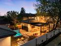 Backyard showcasing a hot tub, fire pit, dining area, and outdoor kitchen for entertaining at 2400 S Columbine St, Denver, CO 80210
