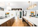 Bright, modern kitchen with pendant lighting, large island, and stainless steel appliances at 2400 S Columbine St, Denver, CO 80210