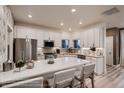 Well-lit kitchen with a spacious island, stainless steel appliances, and ample cabinet space at 920 W 128Th Pl, Westminster, CO 80234
