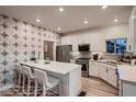 Stylish kitchen with a large island, stainless steel appliances, and a decorative backsplash at 920 W 128Th Pl, Westminster, CO 80234