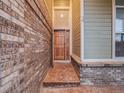 Inviting entryway with wood door and brick and siding features at 14497 Jason Dr, Westminster, CO 80023