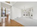 Spacious living room featuring gleaming hardwood floors, neutral paint, and bright natural light at 10383 Coal Ridge St, Firestone, CO 80504