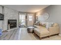 Cozy living room featuring a stone fireplace, neutral decor, and a comfortable leather sofa at 1068 Milo Cir # A, Lafayette, CO 80026