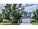Inviting two-story home with a white garage door and a spacious lawn with mature trees for shade and curb appeal at 4178 E 94Th Pl, Thornton, CO 80229