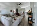 Bright and spacious living room featuring hardwood floors, vaulted ceilings, and stylish, comfortable seating and decor at 4178 E 94Th Pl, Thornton, CO 80229