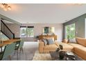Inviting living room with stylish decor, plush seating, and abundant natural light from the windows at 389 Smith Cir, Erie, CO 80516