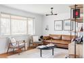 Bright living room featuring a stylish leather sofa and ample natural light at 4571 Beach Ct, Denver, CO 80211