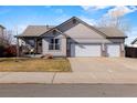 Charming single-Gathering home with a three car garage and well-maintained lawn and siding at 2321 Ance St, Strasburg, CO 80136