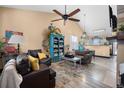 Cozy living room with lots of decorations, hardwood floors, and great natural light at 2321 Ance St, Strasburg, CO 80136