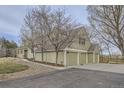 Two-story home with an attached three-car garage, mature trees, and a well-kept lawn at 620 State Highway 52, Erie, CO 80516
