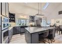 Modern kitchen with stainless steel appliances, a large center island, and stylish pendant lighting at 620 State Highway 52, Erie, CO 80516