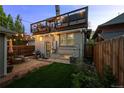 Cozy backyard featuring a private deck above, patio area, and a small lawn, great for outdoor relaxation at 3354 Vallejo St, Denver, CO 80211