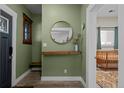 Inviting foyer with stylish decor, a round mirror, and a glimpse into a cozy bedroom at 3354 Vallejo St, Denver, CO 80211
