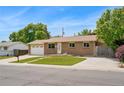 Picture of a one story brick home with an attached garage and a well manicured front lawn at 6180 W 77Th Pl, Arvada, CO 80003