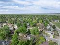Suburban aerial view of a neighborhood featuring green trees and residential streets on a sunny day at 7695 S Harlan St, Littleton, CO 80128