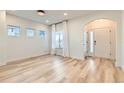 Bright living room featuring wood floors, ample natural light, and a welcoming entrance at 1960 E 166Th Dr, Thornton, CO 80602