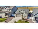 House with a gray roof, stone accents, and a view of mountains and a lake at 2237 Barela Dr, Berthoud, CO 80513