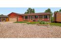Charming brick and siding single Gathering home with gravel front yard and attached garage at 15769 E Greenwood Dr, Aurora, CO 80013