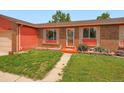 Up close view of charming brick and siding single Gathering home with well kept front yard at 15769 E Greenwood Dr, Aurora, CO 80013