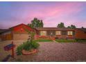 Charming brick and siding single Gathering home with well kept front yard under a twilight sky at 15769 E Greenwood Dr, Aurora, CO 80013