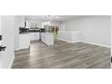 Open kitchen featuring an island, stainless steel appliances, and gray floors for a modern look at 4672 S Lewiston Way, Aurora, CO 80015