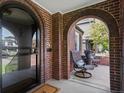 Inviting front porch with comfortable seating, brick arches, and an open view at 1024 S Columbine St, Denver, CO 80209