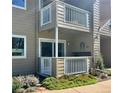 Condo balcony featuring white railings, beige siding, and stylish exterior decor elements at 4945 Twin Lakes Rd # 44, Boulder, CO 80301