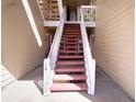 Exterior staircase with white railing and red steps, leading to upper-level units at 4945 Twin Lakes Rd # 44, Boulder, CO 80301