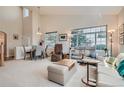 Inviting living room featuring neutral tones, plush seating, and large windows, offering ample natural light and a welcoming atmosphere at 3546 Broadlands Ln # 102, Broomfield, CO 80023